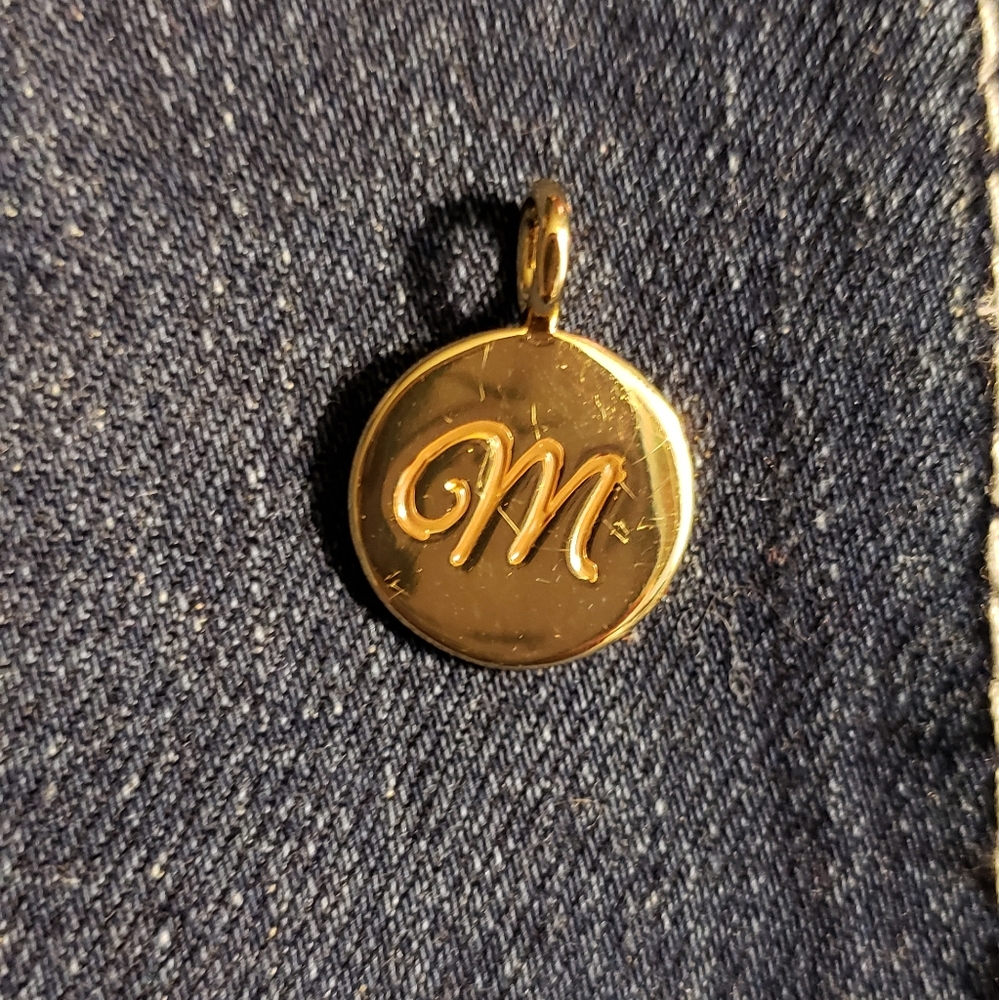 Little dime sized gold M pendant